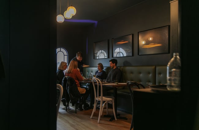 A glimpse of four people dining at Story.
