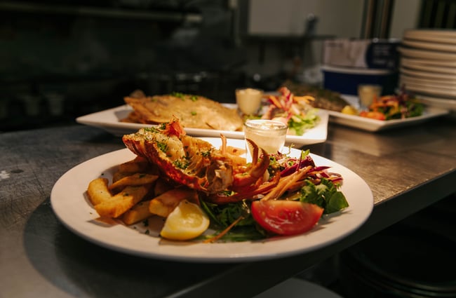 Crayfish and chips on a plate at the pass at Strawberry Tree.