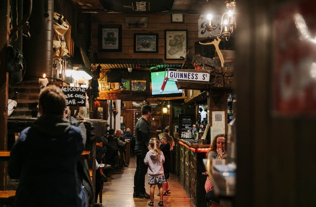 Man standing at the bar with his children at Strawberry Tree.