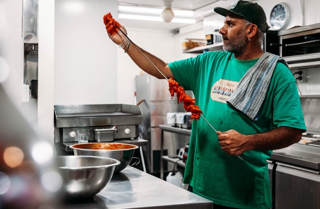 Chef in the kitchen preparing food at Street Eats.