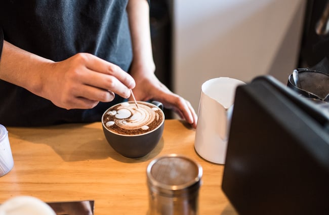 Making coffee behind the counter.