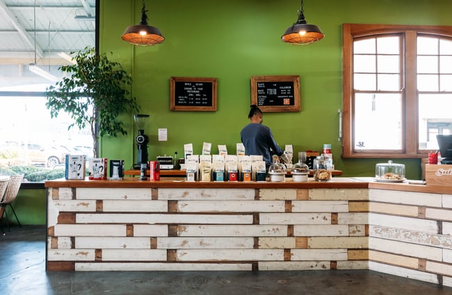 Front coffee counter with barista standing behind at Sublime Coffee Roasters.
