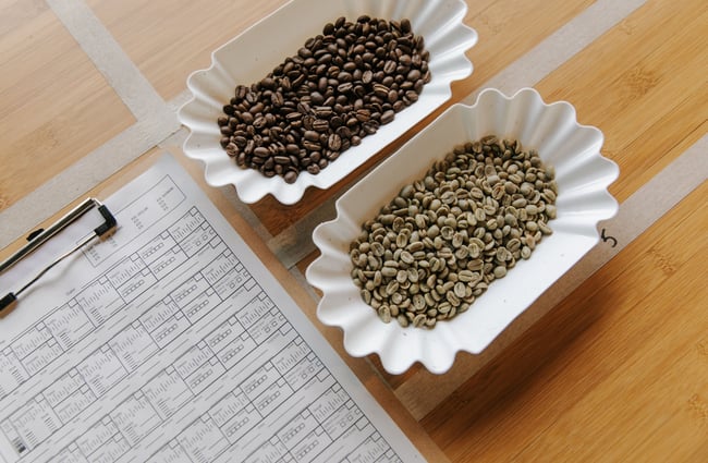 Unroasted and roasted coffee beans in bowls at Sublime Roastery and Brew Bar.