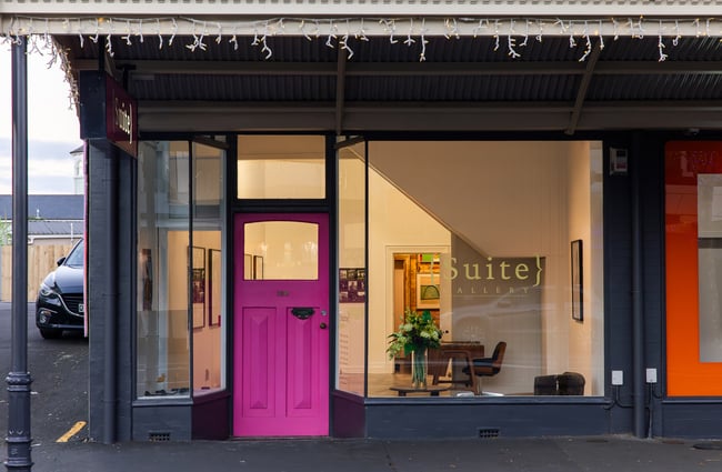 Exterior of Suite Gallery's building in Auckland with pink door