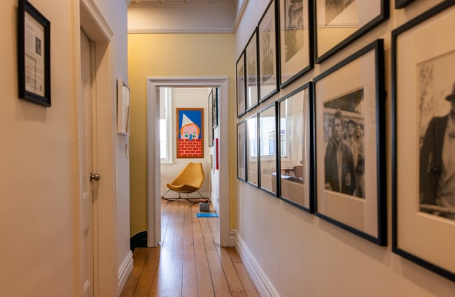 Suite Gallery hallway looking through to gallery rooms with colourful art