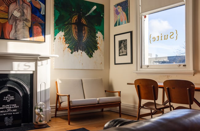 Sofa and chairs by window at Suite Gallery in Auckland