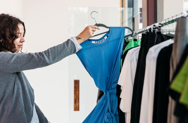 Customer looking at an item of clothing at Sully's.