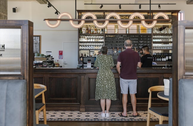 Couple ordering at the bar at Sumner Post Office.