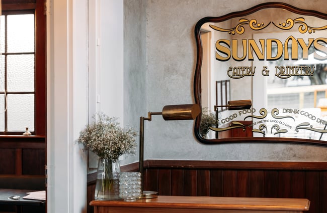 An old mirror on a wall at Sundays Queenstown.