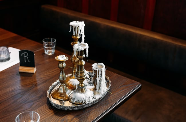 An old candle holder on a table.