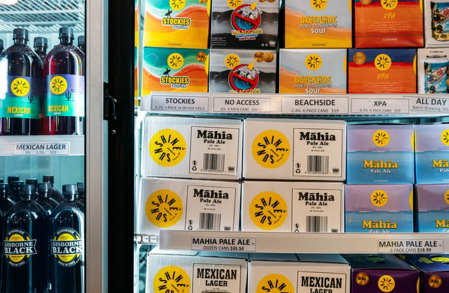 A close up of beer can boxes stacked on top of each other.