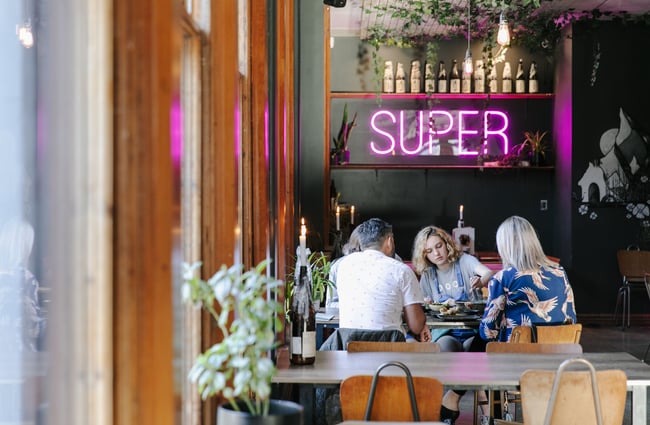 Diners sitting at a table at SUPER.