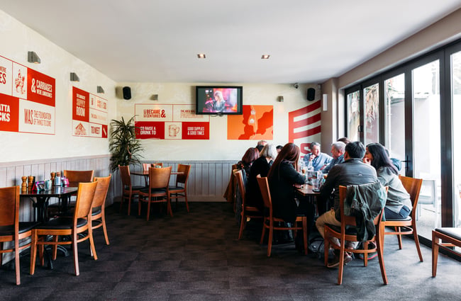 Customers eating at a table inside a restaurant.