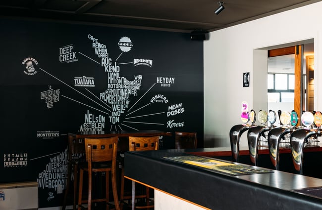 A white and black wall to the left of the bar.