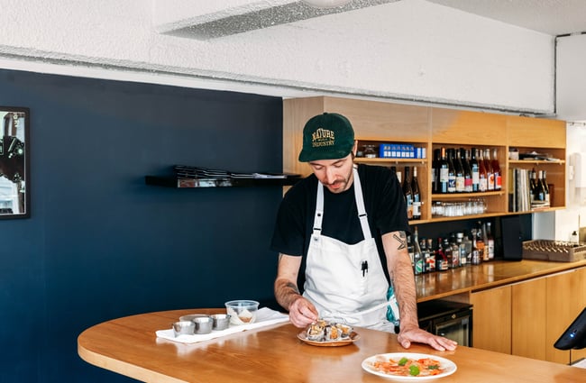 Chef preparing a dish at Supra.