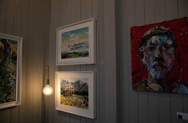 Lightbulb stand with artwork on the walls at Susan Badcock Gallery,  Geraldine.