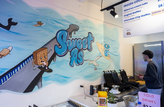 Sweet As art mural on the wall by the front counter at Sweet As Waffles.