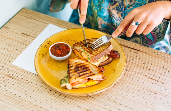 Cheese toastie being eaten.