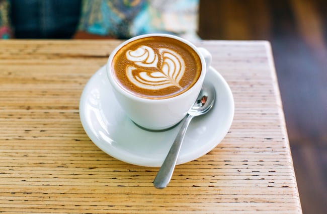 Flat white on a wooden table.