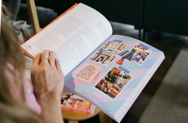 Woman flicking through book at Swoon in Christchurch.