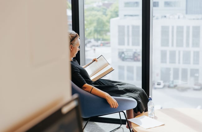 Lady reading a book at the library.