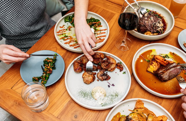 A table full of food at a restaurant.