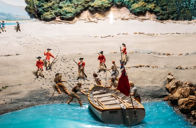 Little people in a little boat on display in a muesum.