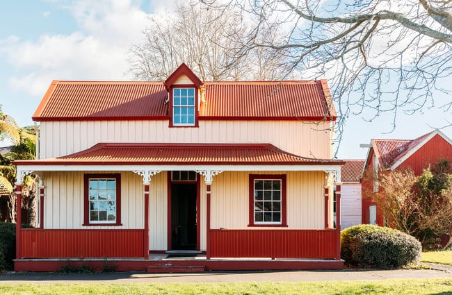 A little cream and red coloured house.