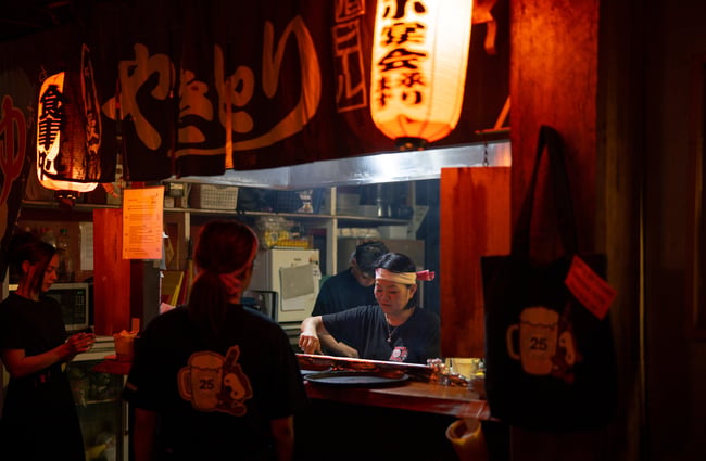 A female staff member working in a restaurant kitchen.