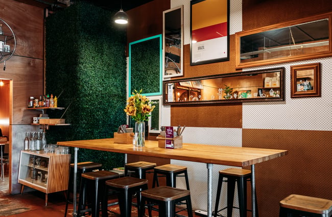 High stools and table seating area at Taper.