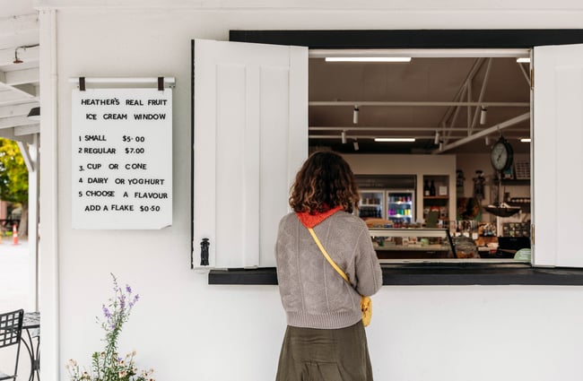 Customer ordering at a window at Tarras Village.