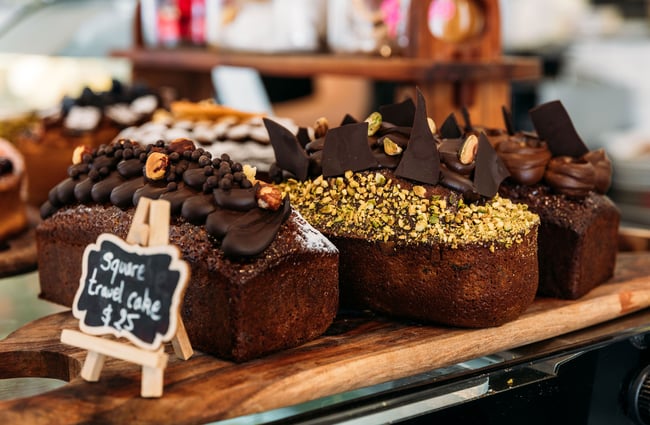 Close up of handmade French cakes with ganache, hazelnuts and pistachios on top