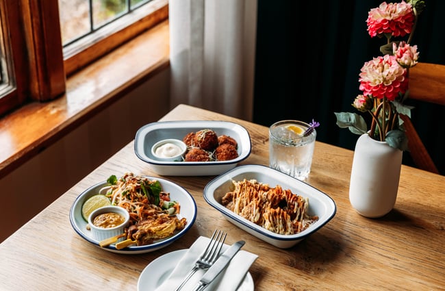 Several food dishes set out on the table at Tatum.