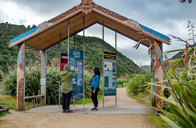 Two people looking at information boards.