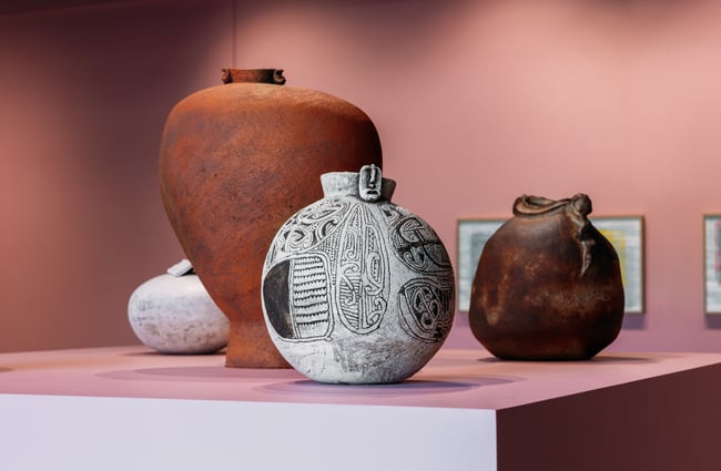 A close up of vases on a plinth.