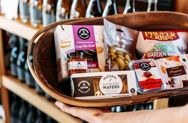 Packets of Crisps and biscuits in a basket.