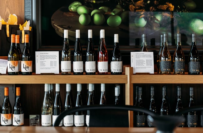 A close up of wine bottles on display on shelves.