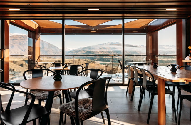 A view of Central Otago from inside a restaurant with large windows.