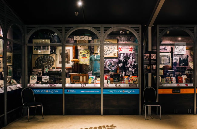 1950s rugby display behind arches glass display boxes.