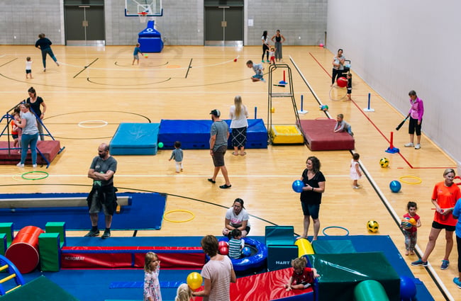 Gym courts being used by people.