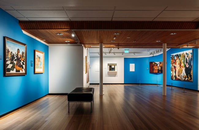 Blue exhibition walls with art on display at Waikato Museum, Hamilton.