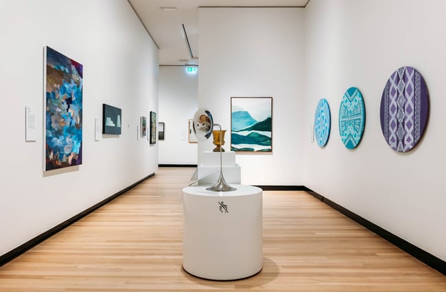 White walls with exhibits on display on the wall at Waikato Museum.