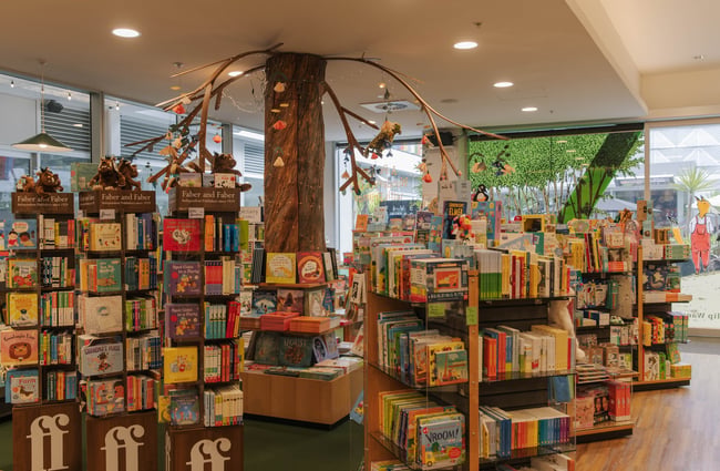 Interior view of Telling Tales with multiple bookcases and rotating displays.