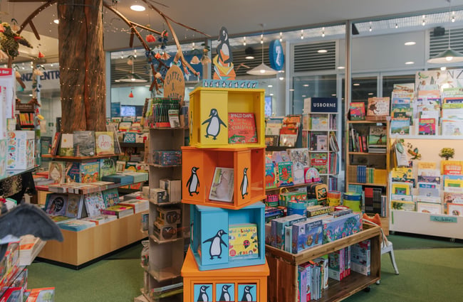 A stack of colourful, twisted cubes with the Penguin Books penguin logo forms a display bookcase in Telling Tales.