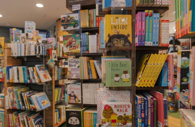 Close up of children's books displayed on a rotating bookcase inside Telling Tales.