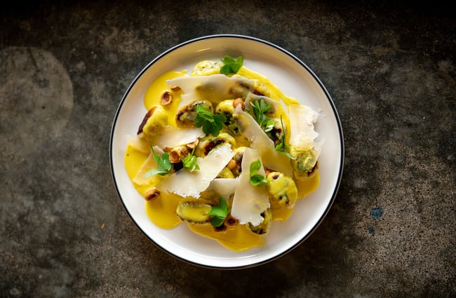 A plate of yellow pasta on a plate.