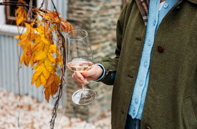Customer holding a glass of wine at Terra Sancta.