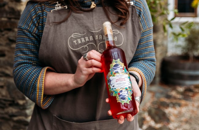 Terra Sancta staff member holding a bottle of rose.