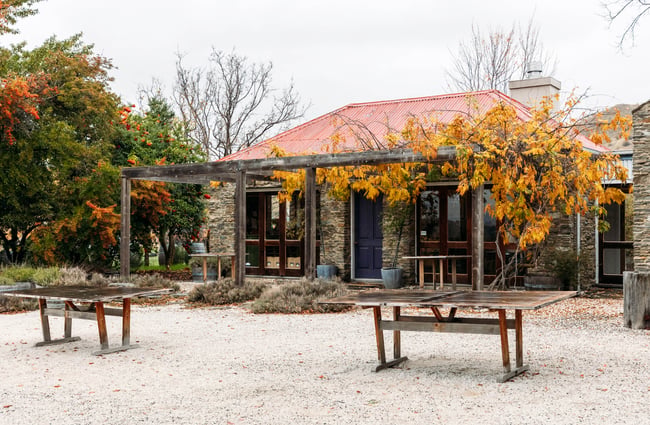 Schist building exterior and outdoor tables at Terra Sancta.