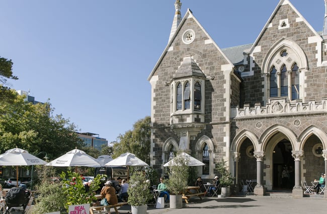 The Arts Centre facade with people sitting under umbrellas at Frances Nation Cafe